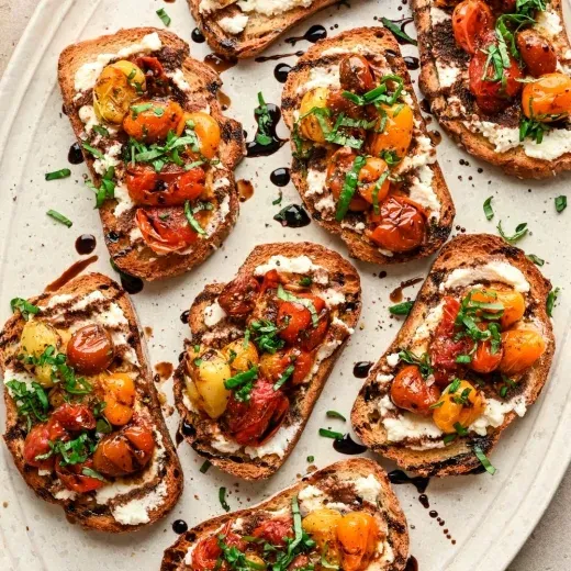 Fat med crostini toppade med vispad ost, rostade körsbärstomater och gräslök